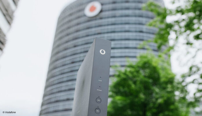 Vodafone-Router Vodafone Gebäude mit Router im Vordergrund